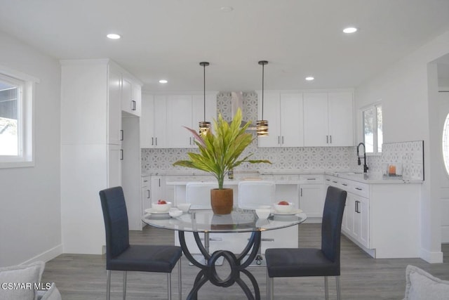 dining room with hardwood / wood-style flooring and sink