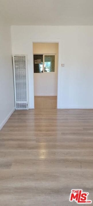 unfurnished room with light wood-type flooring