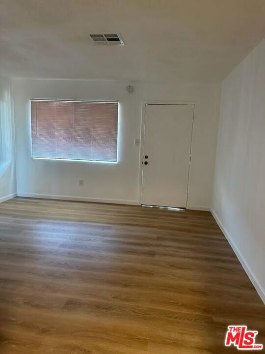 unfurnished room featuring hardwood / wood-style floors