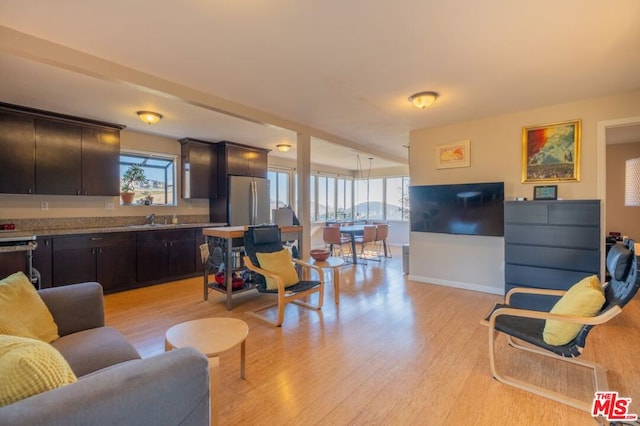 living room with sink and light wood-type flooring