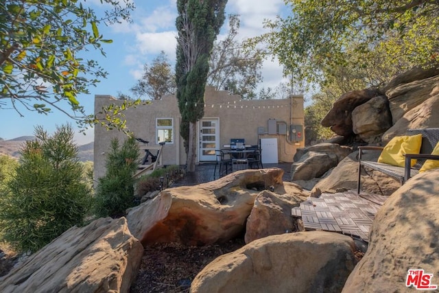 exterior space with a mountain view and a patio area