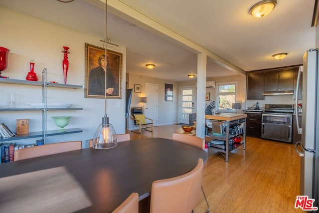 dining space with light wood-type flooring