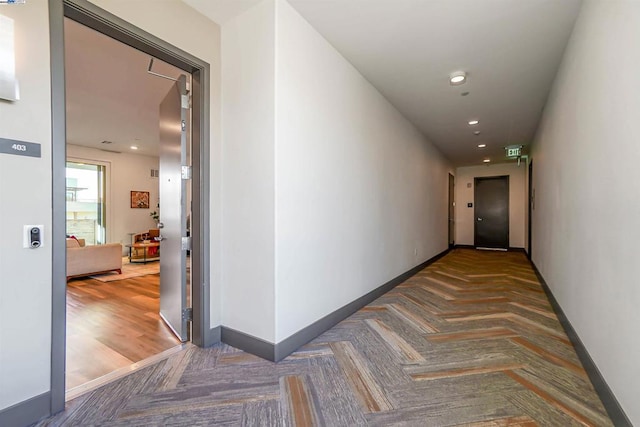 hallway with dark parquet floors