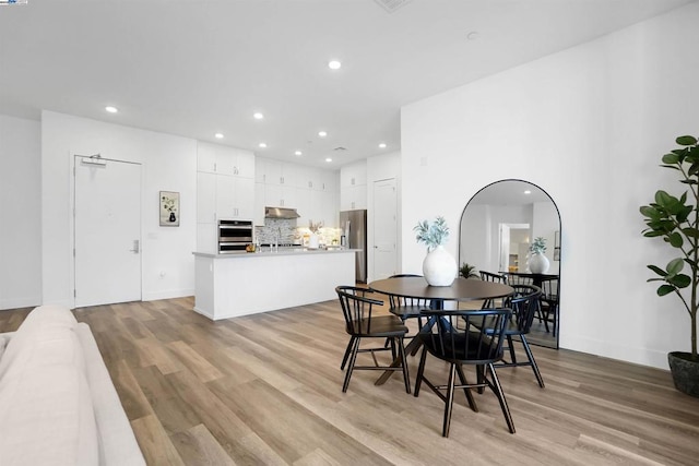 dining space with light hardwood / wood-style flooring