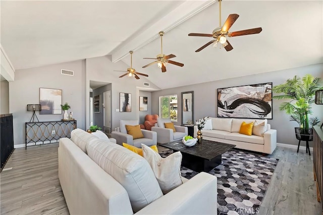 living room featuring light hardwood / wood-style flooring and vaulted ceiling with beams