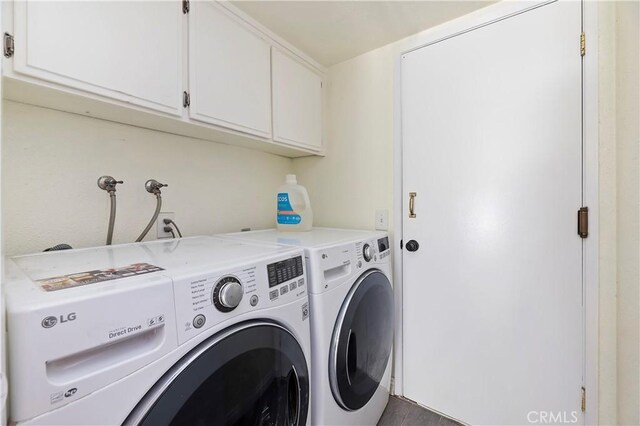 clothes washing area with cabinets and separate washer and dryer