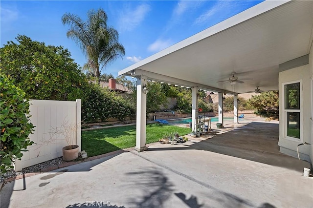 view of patio / terrace with ceiling fan and a fenced in pool