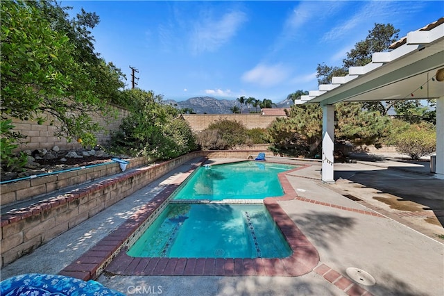 view of pool with a mountain view and a patio