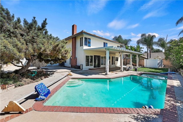 rear view of property featuring a patio and a pergola