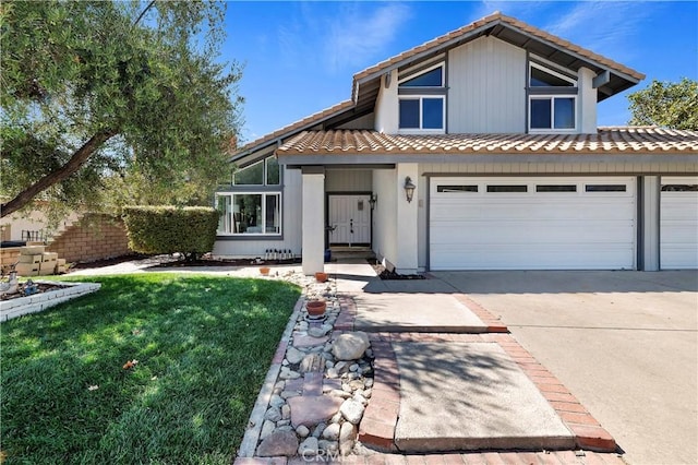 view of front of property with a front lawn and a garage