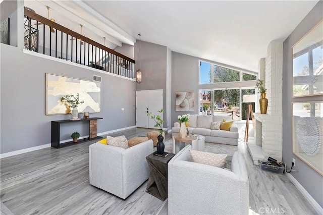 living room with high vaulted ceiling and hardwood / wood-style floors