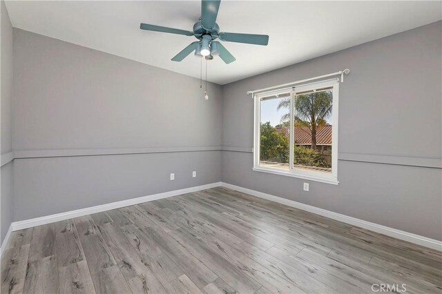 spare room with ceiling fan and light hardwood / wood-style floors