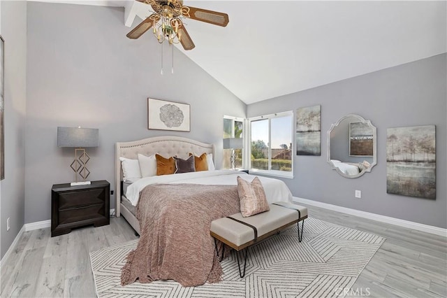 bedroom featuring ceiling fan, light hardwood / wood-style flooring, and high vaulted ceiling