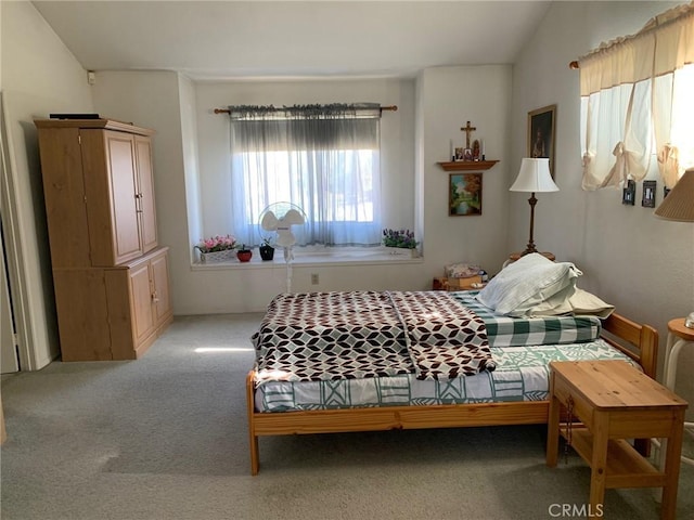 carpeted bedroom featuring lofted ceiling