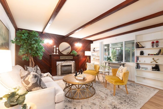 living room with wooden walls, beamed ceiling, and hardwood / wood-style flooring