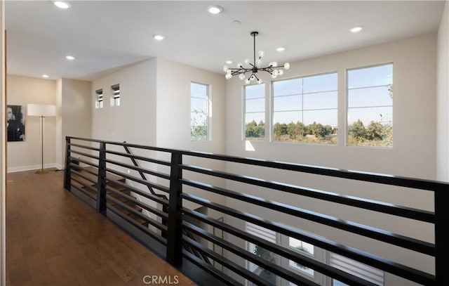 hall featuring dark hardwood / wood-style floors and a notable chandelier