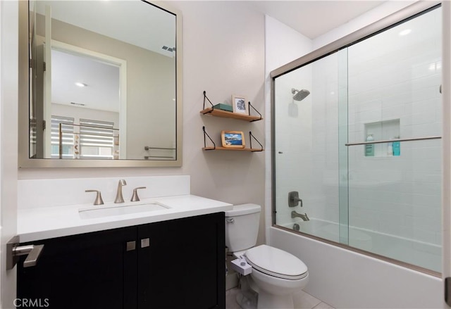 full bathroom with toilet, vanity, and shower / bath combination with glass door