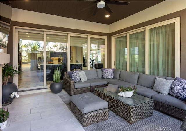 sunroom / solarium featuring ceiling fan and wood ceiling