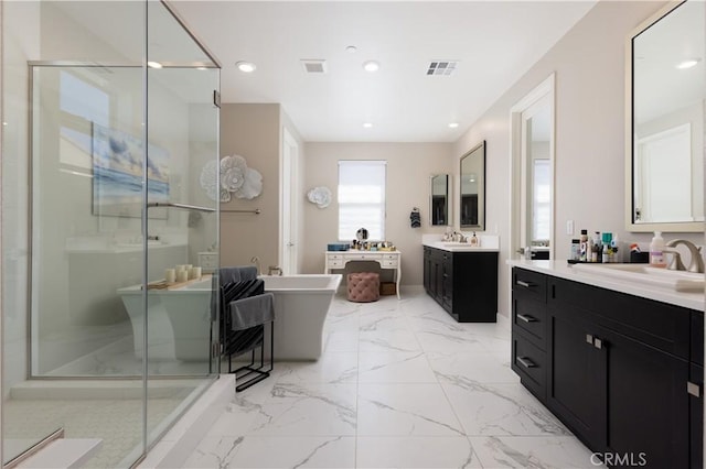 bathroom featuring vanity and independent shower and bath