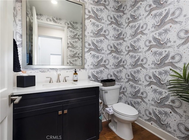 bathroom with wood-type flooring, toilet, and vanity