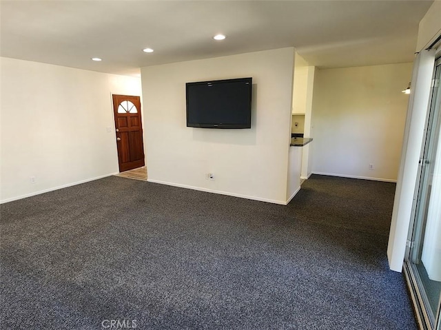 unfurnished living room featuring dark colored carpet