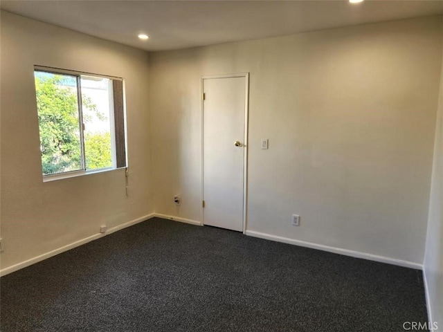 empty room with dark carpet