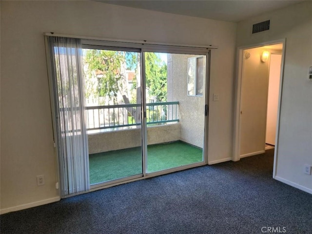 doorway featuring a wealth of natural light and dark carpet