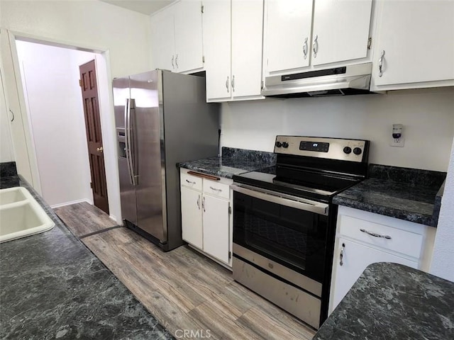 kitchen with sink, white cabinetry, appliances with stainless steel finishes, and light wood-type flooring