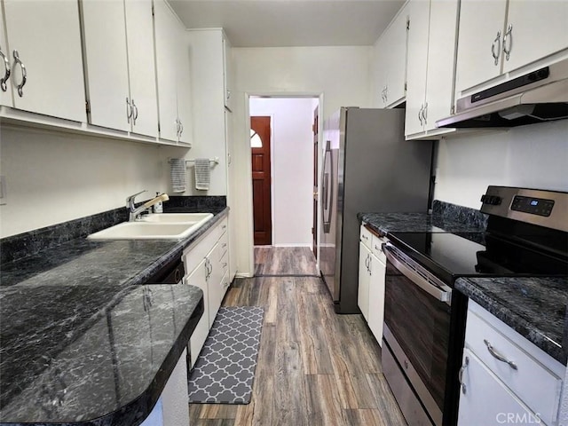 kitchen with hardwood / wood-style flooring, stainless steel appliances, white cabinets, and sink