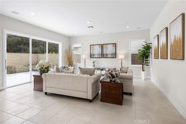 living room featuring light tile patterned floors, baseboards, visible vents, and recessed lighting