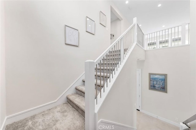 staircase with a towering ceiling