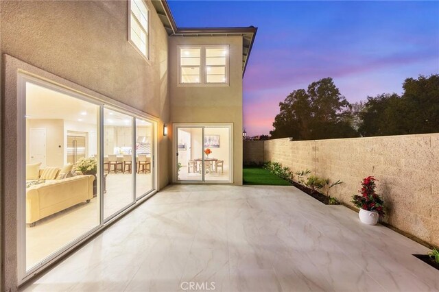 view of patio terrace at dusk