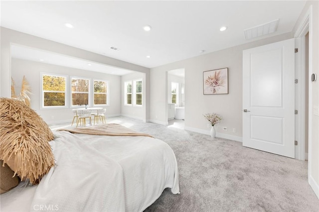 carpeted bedroom with baseboards, visible vents, ensuite bathroom, and recessed lighting