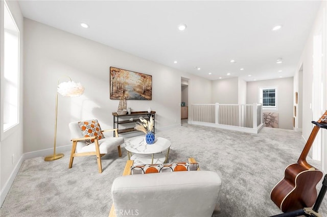 living area with carpet floors, recessed lighting, plenty of natural light, and an upstairs landing