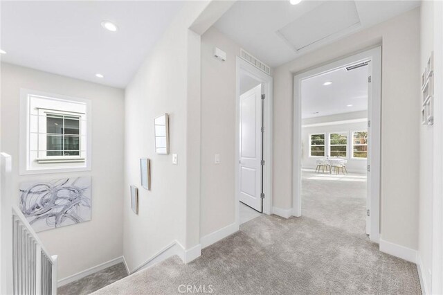 hallway with light colored carpet