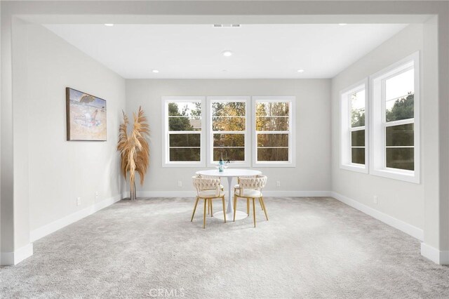 unfurnished dining area with light carpet