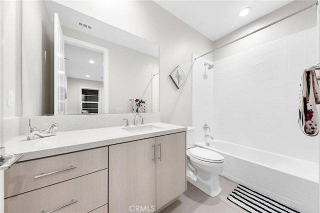 full bath featuring double vanity, shower / bath combination, visible vents, toilet, and a sink