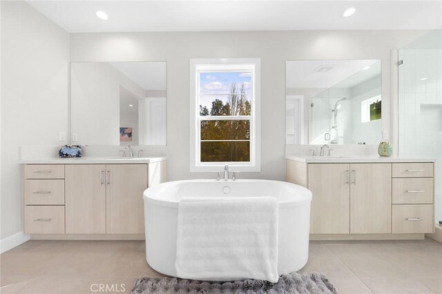 bathroom with vanity, independent shower and bath, and tile patterned flooring