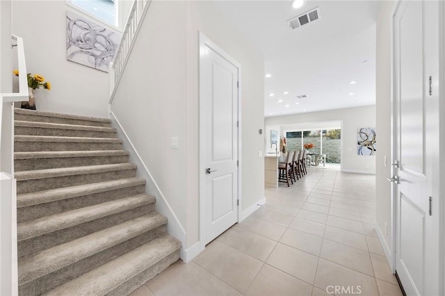 staircase with baseboards, recessed lighting, visible vents, and tile patterned floors