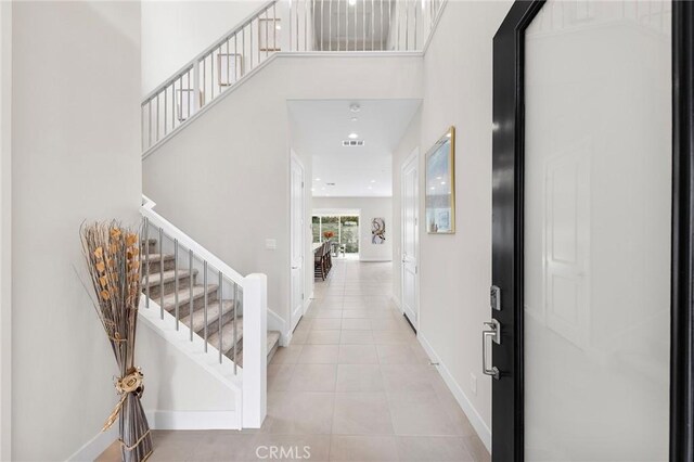 tiled foyer entrance with a high ceiling