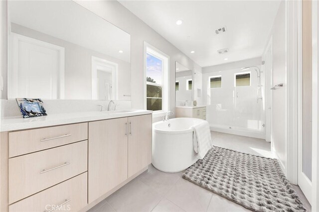 bathroom with vanity, independent shower and bath, and tile patterned flooring