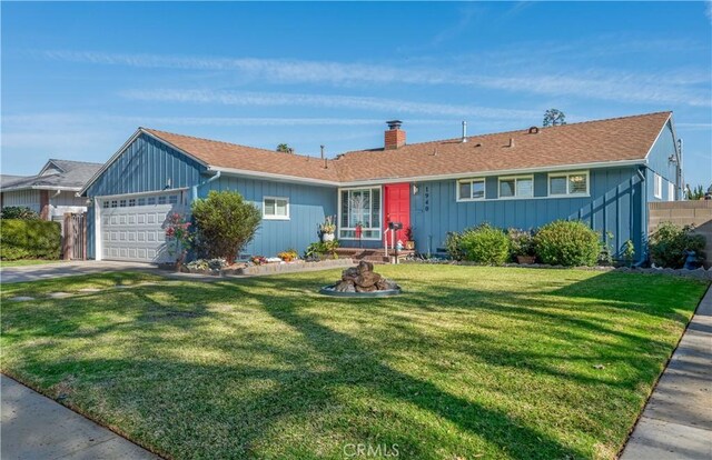 ranch-style house featuring a front lawn and a garage