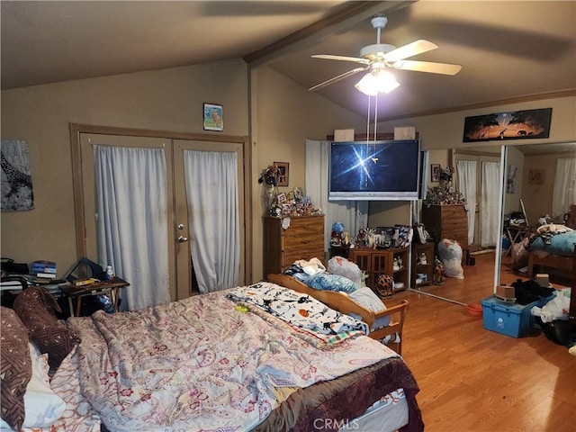 bedroom with ceiling fan, wood-type flooring, a closet, and lofted ceiling with beams