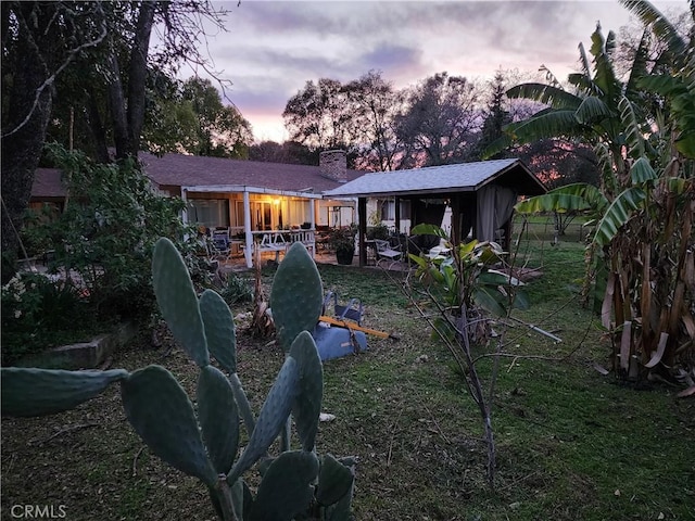 view of back house at dusk