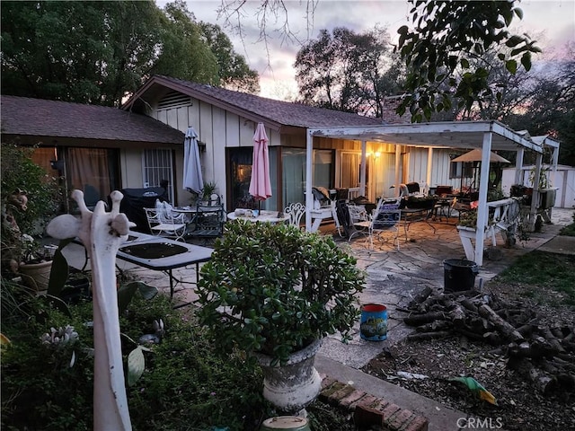 back house at dusk with a patio