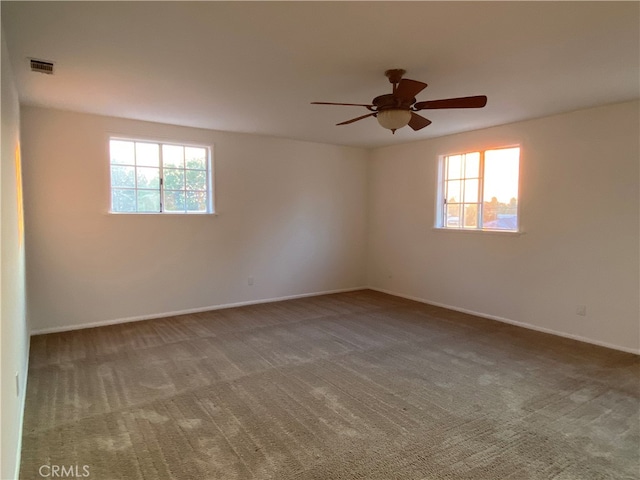 unfurnished room featuring ceiling fan and carpet flooring