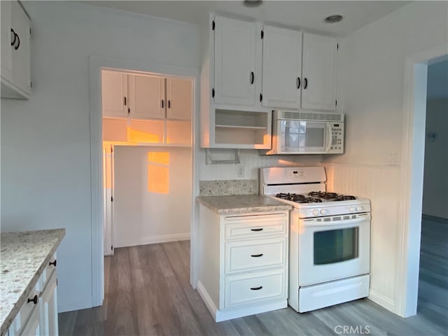 kitchen with dark wood-type flooring, white cabinetry, and white appliances