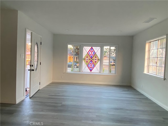 unfurnished room with dark wood-type flooring