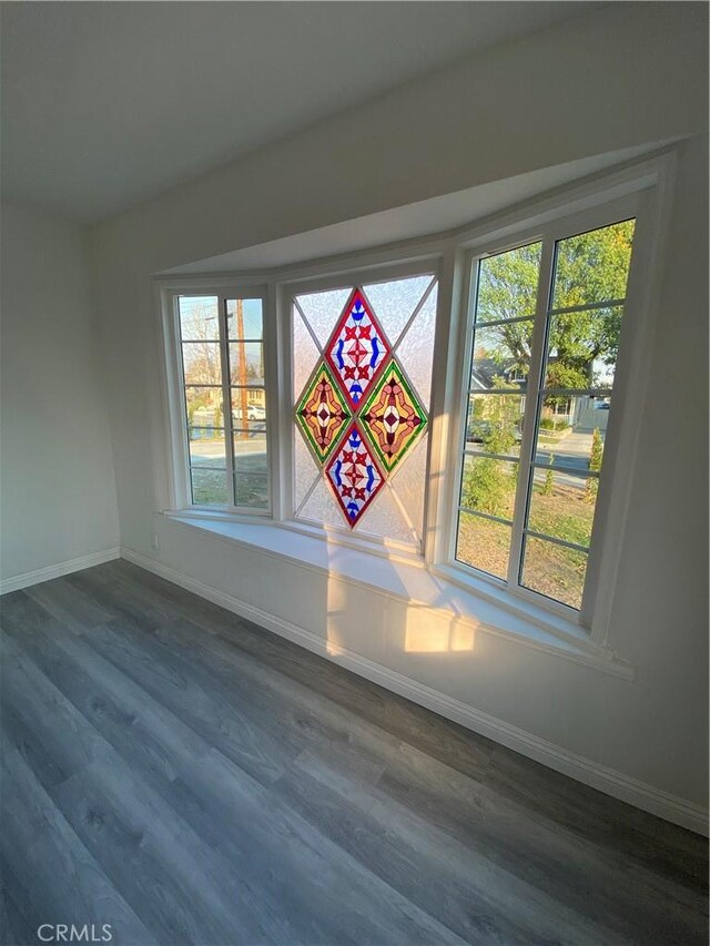 empty room with dark hardwood / wood-style flooring