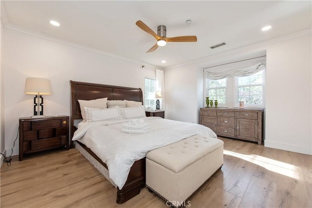 bedroom with ceiling fan, crown molding, and light hardwood / wood-style floors